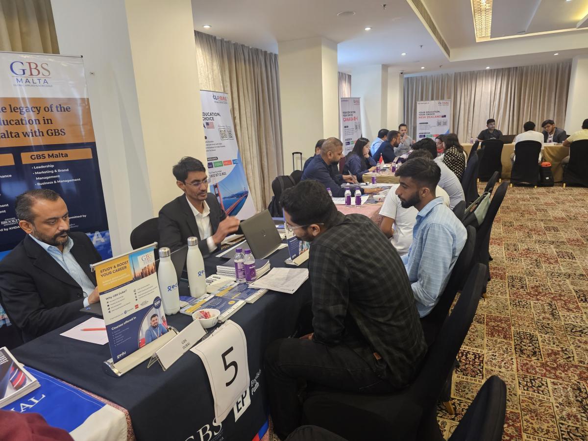 Students comparing international study options with university representatives